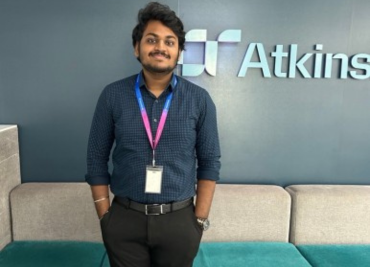 Sujith in front of atkinsrealis logo